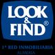 Logo de "Look & Find", 1ª red inmobiliaria, texto en azul sobre fondo blanco, Almería.