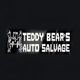 Sign reading "Teddy Bear's Auto Salvage" with line art of a teddy bear and car parts.