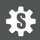 Zahnrad-Symbol mit einem "S" in der Mitte auf grauem Hintergrund.