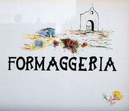 Insegna con scritta "FORMAGGERIA", disegni di paesaggio, fiori e piccola chiesa.