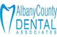 Logo of Albany County Dental Associates with a blue tooth graphic.