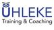 Logo mit Eule: "ÜHLEKE Training & Coaching" in Blau und Schwarz.