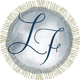 Elegant monogram "LF" in blue on a textured circle with a decorative border.