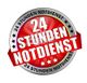 Roter Button mit der Aufschrift "24 Stunden Notdienst" umrandet von einem silbernen Kreis.