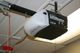 Ceiling-mounted LiftMaster garage door opener with a red manual release cord hanging down.