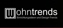 Logo mit Schriftzug "Wohntrends" und Slogan "Einrichtungsideen und Design-Trends" auf schwarzem Hintergrund.