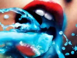 Roter Mund mit weißen Zähnen, blauer Spritzer flüssiger Textur.