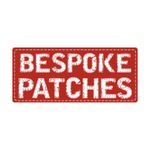 Red patch with white embroidered text: "BESPOKE PATCHES".