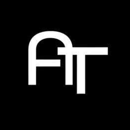 Bold white letters "AT" on a black background.