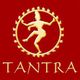 Logo dourado de figura dançante com a palavra "TANTRA" em fundo vermelho.