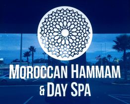 Sign reads "Moroccan Hammam & Day Spa" with intricate geometric design above it.