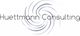 "Logo von Huettmann Consulting mit spiralförmigem Design im Hintergrund."