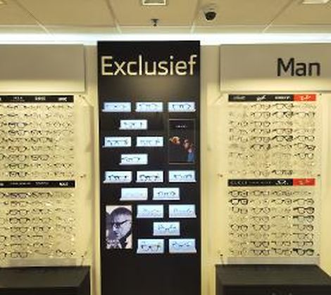 Brillenwinkel display met borden 'Exclusief' en 'Man', met diverse brillen getoond.