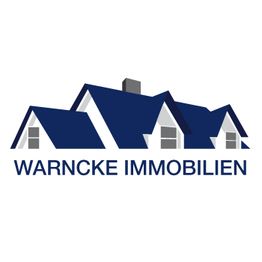 Logo mit blauen Hausdächern und dem Schriftzug "Warncke Immobilien".