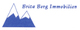 Logo mit blauen Berggipfeln und dem Text: "Brita Berg Immobilien".