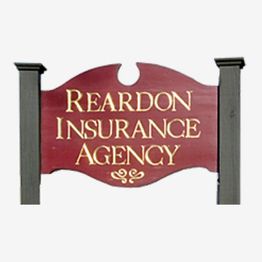 Sign reading "Reardon Insurance Agency" in gold on a red background with decorative posts.