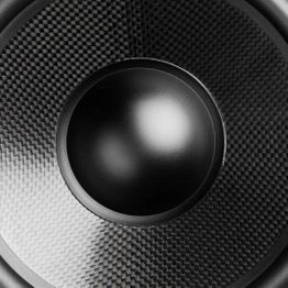 Close-up of a black speaker cone with a textured surface and a central dome.