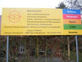 Gelbes Firmenschild mit Angeboten für Heizsysteme, Sonnenlogo und Kontaktinformationen.
