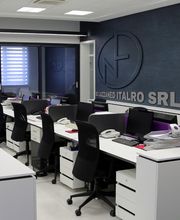 Ufficio moderno con scrivanie, sedie nere e parete blu. Marchio "SRL" sul muro.