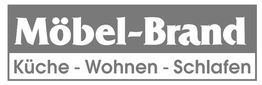 Graues Logo mit „Möbel-Brand“ und den Wörtern „Küche - Wohnen - Schlafen“ darunter.