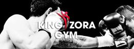 Zwei Boxer im Ring, dicht nebeneinander. Im Vordergrund steht "King Zora Gym".