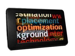 Tablet displaying colorful overlapping text, including "optimization" and "placement."