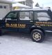 Taxi covered in snow, parked by a house. "Mr. Kab Taxi" with a phone number on the door.