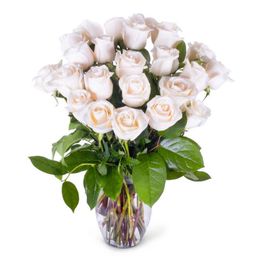 A bouquet of white roses in a glass vase with green leaves, displayed on a white background.