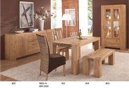 Esszimmer mit Holzmöbeln: Tisch, Stühle, Bank, Schrank und Kommode auf Teppichboden.