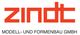Logo mit rotem Text "zindt" und schwarzem Text "MODELL- UND FORMENBAU GMBH" darunter.