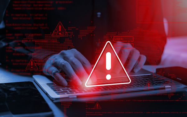 Bedrohungszeichen bei Laptop mit Mann