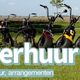 Rij Solex- en e-choppers staan buiten met tekst "Solexverhuur Sloten" op een groene achtergrond.