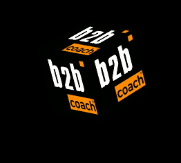 Schwarzer Würfel mit "b2b" in Weiß und "coach" in Orange auf schwarzem Hintergrund.