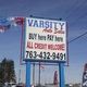 Sign for Varsity Auto Sales: "Buy here, Pay here. All credit welcome. 763-432-9491."