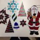 Stained glass shapes including stars, trees, a bell, and Santa on a white background.