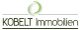 Logo von Kobelt Immobilien mit grünem Kreis über dem Schriftzug.
