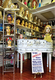 Wig shop display with various mannequin heads and sign advertising an American collection sale.