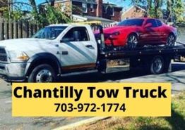 Tow truck carrying a red car, text: "Chantilly Tow Truck, 703-972-1774."