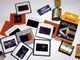 Dias und Filmrollen auf einem Tisch, teils von Kodak und Porst.