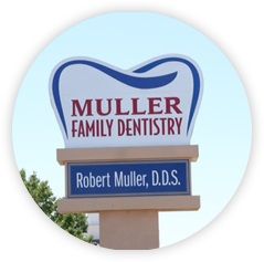 Sign for Muller Family Dentistry, Dr. Robert Muller, D.D.S., shaped like a tooth.