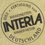 Stempel mit dem Text: "Idee + Fertigung von Marionetten Interia Manufaktur Deutschland".