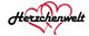 Schriftzug "Herzchenwelt" in Schwarz über roten, ineinander verschlungenen Herzen.