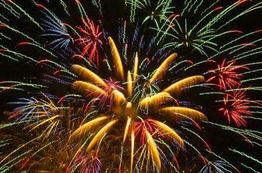 Colorful fireworks bursting against a dark sky.