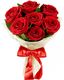 Bouquet of red roses wrapped in white paper with a red ribbon.