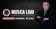 Smiling man in a suit next to Musca Law logo and text "Aggressive Criminal Defense."