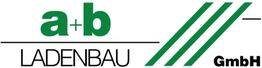 Logo mit grünem "a+b" über "LADENBAU" und Dreiecke daneben, Text "GmbH" rechts in Schwarz.
