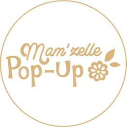 Bannière circulaire "Mam'zelle Pop-Up" avec fleur et feuilles dorées.