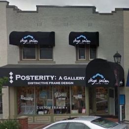 Storefront of Posterity Gallery and Skye Salon with black awnings and signage.