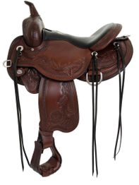 Brown leather horse saddle with detailed floral patterns and black straps.