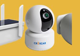 White security camera and part of a device with antennas on a yellow background.